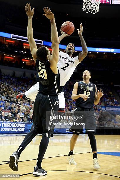 Octavius Ellis of the Cincinnati Bearcats goes up for a shot as A.J. Hammons of the Purdue Boilermakers defends during the second round of the 2015...