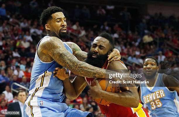 James Harden of the Houston Rockets gets fouled by Wilson Chandler of the Denver Nuggets during their game at the Toyota Center on March 19, 2015 in...