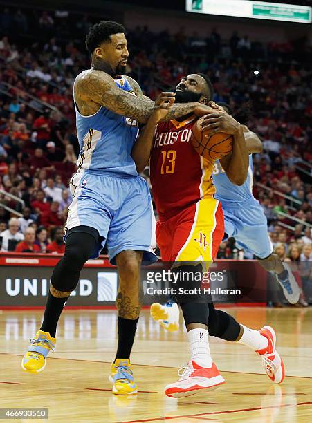 James Harden of the Houston Rockets gets fouled by Wilson Chandler of the Denver Nuggets during their game at the Toyota Center on March 19, 2015 in...