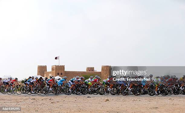 The peloton makes their way past the Al Zubara Fort during stage two of the 2014 Ladies Tour of Qatar from Al Zubara to Madinat Al Shamal on February...