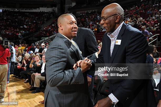 Melvin Hunt of the Denver Nuggets and Clyde Drexler shake hands before a game against the Houston Rocketson March 19, 2015 at the Toyota Center in...