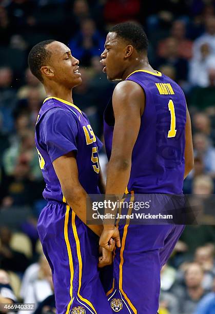 Jarell Martin of the LSU Tigers reacts with teammate Tim Quarterman after a play against the North Carolina State Wolfpack in the first half during...
