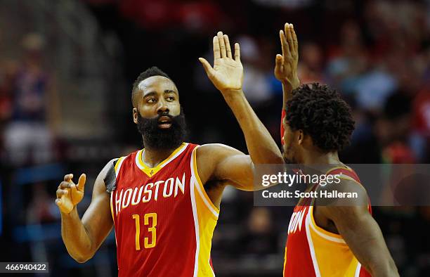 James Harden and Patrick Beverley of the Houston Rockets celebrate after Harden hit a three-point shot during their game against the Denver Nuggets...