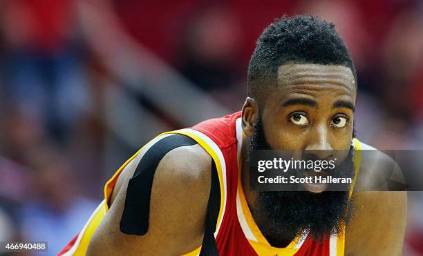 James Harden of the Houston Rockets waits on the court during their game against the Denver Nuggets at the Toyota Center on March 19, 2015 in...