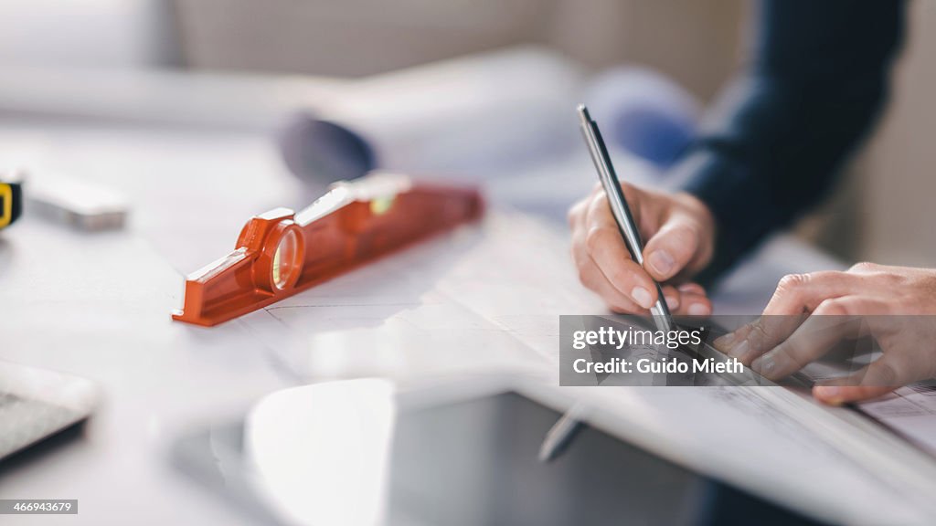 Woman hand, ball pen and key plan