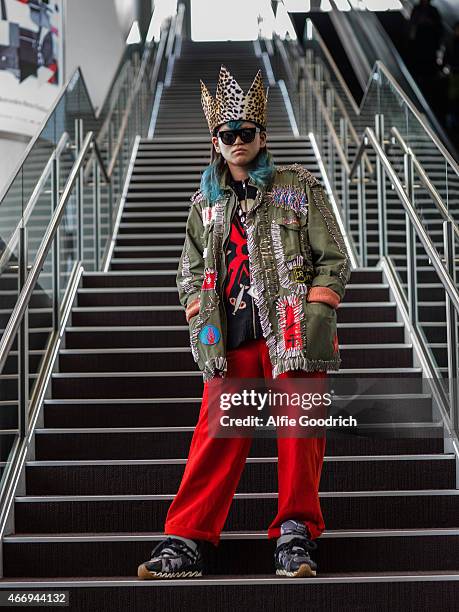 Guest is seen wearing jacket by Anti, spectacles by Wild, cardigan by Walter and trousers by Garrison during the Mercedes Benz Fashion Week TOKYO...