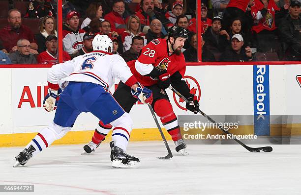 Matt Kassian of the Ottawa Senators skates against Douglas Murray of the Montreal Canadiens at Canadian Tire Centre on January 16, 2014 in Ottawa,...