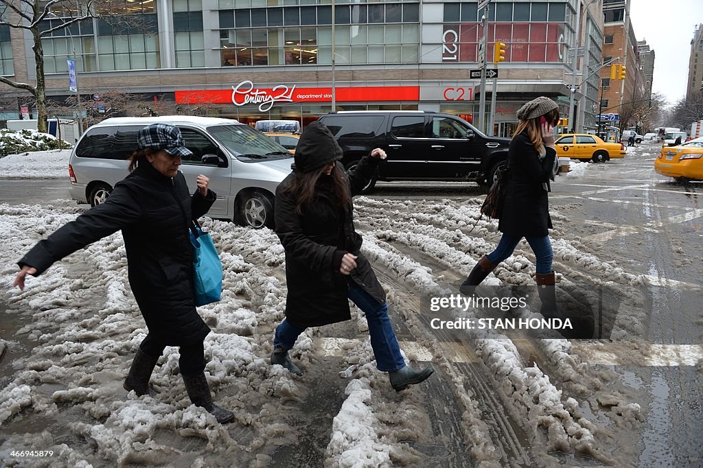 People walk through snow and slush along Broadway near Lincoln Center ...