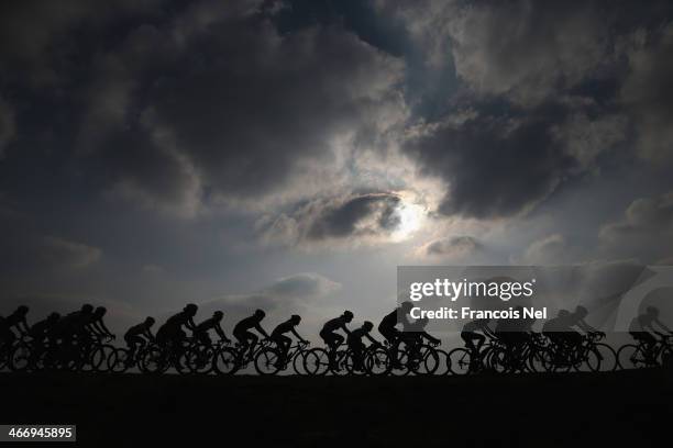 The peloton rides through Al Mafjar during stage two of the 2014 Ladies Tour of Qatar from Al Zubara to Madinat Al Shamal on February 5, 2014 in...