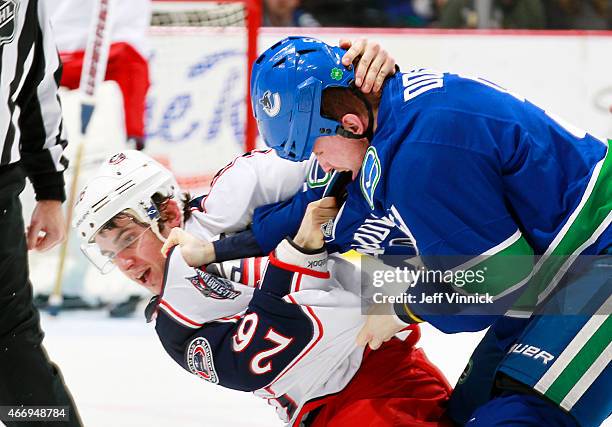 Corey Tropp of the Columbus Blue Jackets and Derek Dorsett of the Vancouver Canucks fight during their NHL game at Rogers Arena March 19, 2015 in...