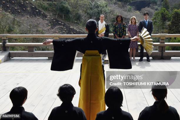 First Lady Michelle Obama , US Ambassador to Japan Caroline Kennedy and her son Jack Schlossberg watch a student perform a Noh play during a visit to...