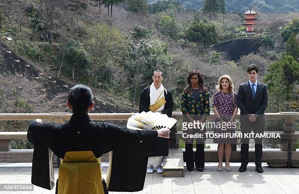 First Lady Michelle Obama , US Ambassador to Japan Caroline Kennedy and her son Jack Schlossberg watch a student perform a Noh play during a visit to...