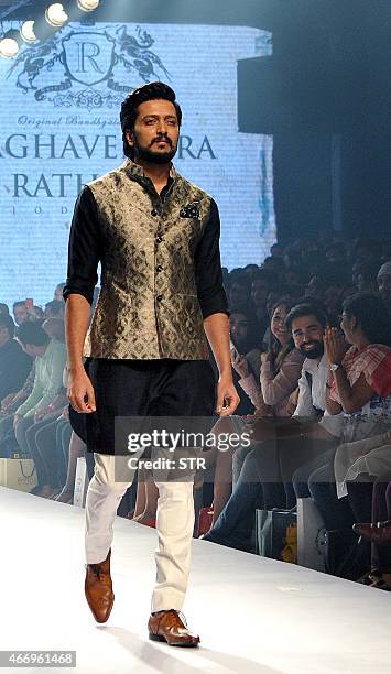 Indian Bollywood actor Ritesh Deshmukh showcases a creation by designer Raghavendra Rathore on the second day of the Lakme Fashion Week summer/resort...