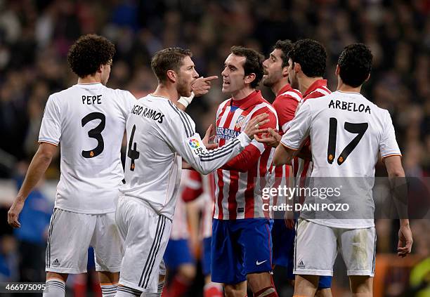 Real Madrid's Portuguese defender Pepe argues with Atletico Madrid's Uruguayan defender Diego Godin during the Spanish Copa del Rey semifinal...