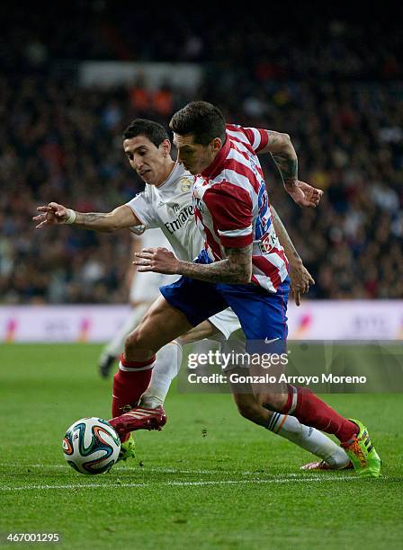 Angel Di Maria of Real Madrid CF competes for the ball with Cristian Rodriguez alias El Cebolla of Atletico de Madrid during the Copa del Rey...