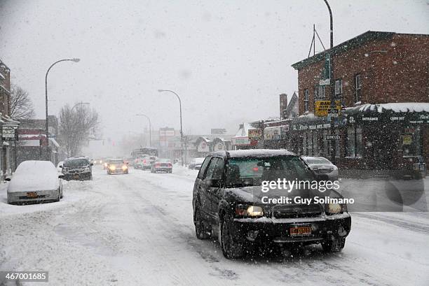 Motorists drive along Monroe Avenue during a snow storm on February 5, 2014 in Rochester, New York. An additional foot of snow blanketed Western New...