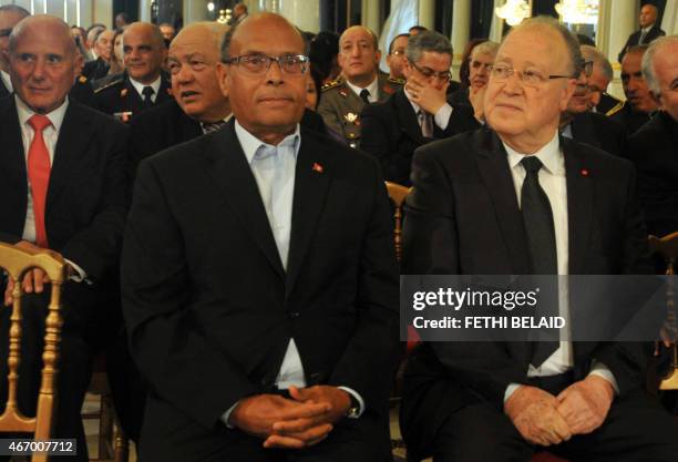 Former Tunisian president Moncef Marzouki sits next to former constituent assembly president Mustapha Ben Jaafar during a ceremony marking the 59th...