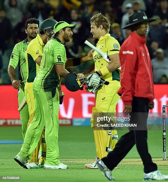 Pakistan's player Shahid Afridi congratulates Australia's batsman Shane Watson for his victory in the 2015 Cricket World Cup quarter-final match...