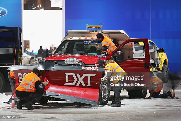 Workers prepare a Ford F550 truck for display at the Chicago Auto Show on February 5, 2014 in Chicago, Illinois. The show, which is held at McCormick...