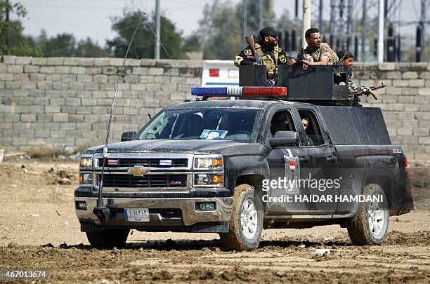Iraqi police leave the holy city of Najaf as they head, alongside fighters from the Saraya al-Salam , a group formed by Iraqi Shiite Muslim cleric...