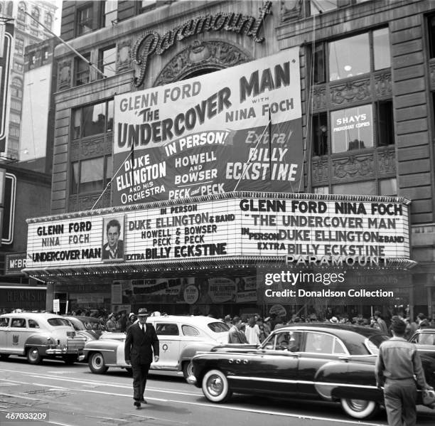 The marquee of the Paramount Theatre reads "Glenn Ford 'The Undercover Man' with Nina Foch, in person Duke Ellington and his Orchestra, Howell And...