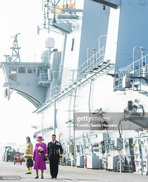 Queen Elizabeth II walks along the flight deck as she visits HMS Ocean on March 20, 2015 in Plymouth, England.