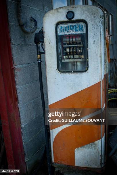 An old gas pump is seen in front of a farm on March 18, 2015 near Niort, eastern France. Thirty years after introducing quotas to combat the butter...