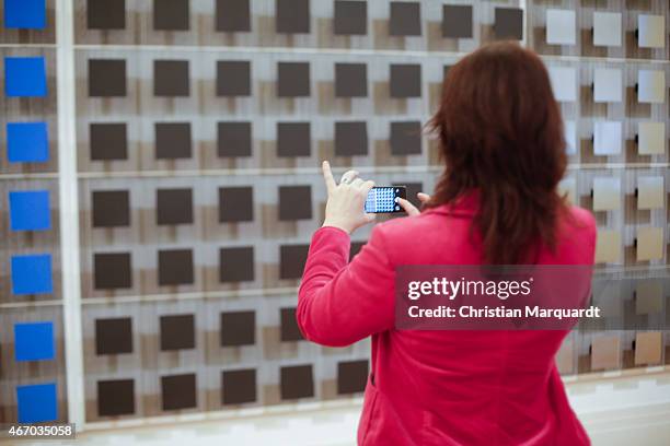 Visitor takes a photo of work by Jesus Rafael Soto during the press opening of 'Zero - Die internationale Kunstbewegung der 50er und 60er Jahre'...