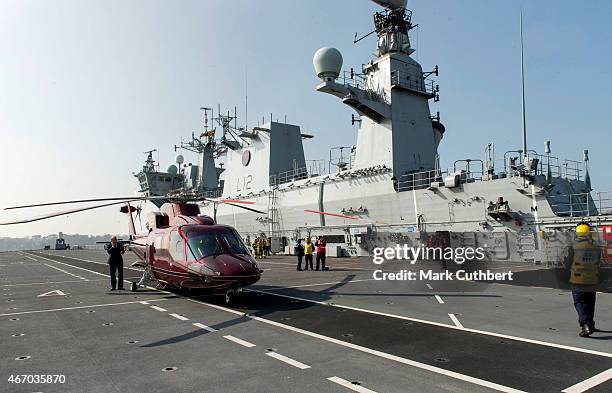 Queen Elizabeth II departs from the flight deck of HMS Ocean after an official visit on March 20, 2015 in Plymouth, England.