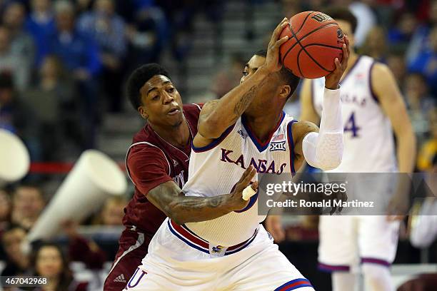 Daniel Mullings of the New Mexico State Aggies defends against Frank Mason III of the Kansas Jayhawks during the second round of the 2015 NCAA Men's...