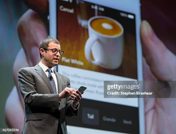 Starbucks chief digital officer Adam Brotman demonstrates mobile order and pay on the the company's app during the Starbucks annual shareholders...