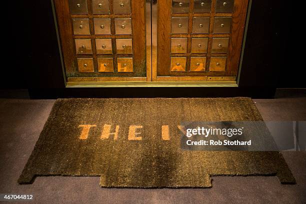 Mat sits in front of the Ivy entrance doors, which are valued at between ?800 and ?1200, at Sotheby's auction house on March 20, 2015 in London,...