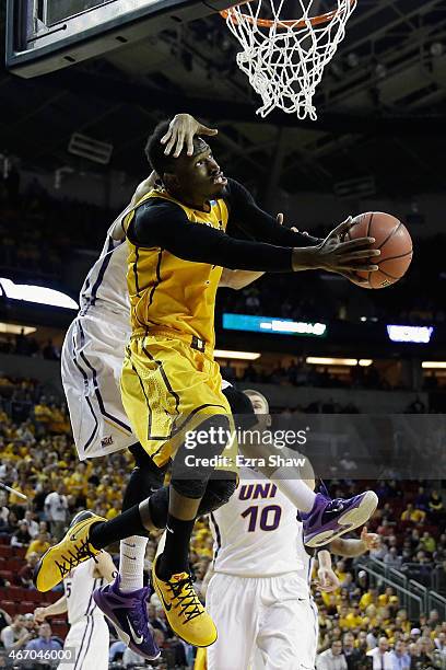 Jeremy Morgan of the Northern Iowa Panthers jumps to block a shot by Derek Cooke Jr. #11 of the Wyoming Cowboys during the first half of their game...