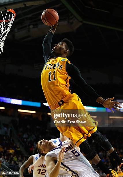 Derek Cooke Jr. #11 of the Wyoming Cowboys jumps to take a shot over Matt Bohannon of the Northern Iowa Panthers during the first half of their game...