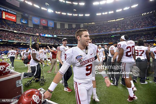 Quarterback Trevor Knight of the Oklahoma Sooners sets his helmet down in the fourth quarter during their win against the Alabama Crimson Tide in the...