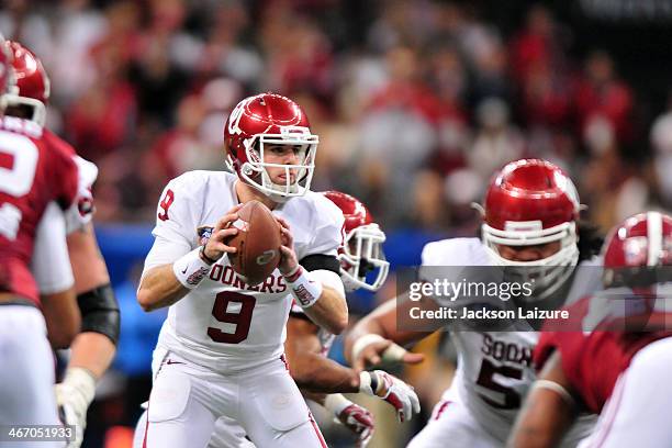 Quarterback Trevor Knight of the Oklahoma Sooners looks to run the ball against the Alabama Crimson Tide during their win in the the BCS Sugar Bowl...