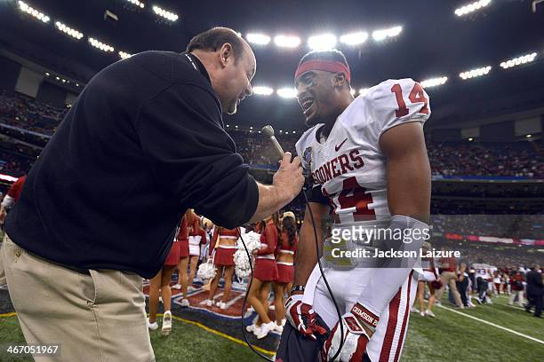 Cornerback Aaron Colvin of the Oklahoma Sooners celebrates with sportscaster James Hale after their win against the Alabama Crimson Tide in the BCS...