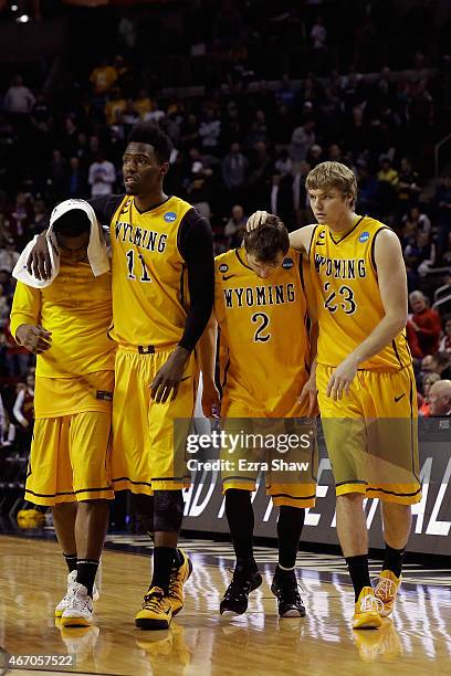 Derek Cooke Jr. #11, Riley Grabau, and Jason McManamen of the Wyoming Cowboys walk off the court following their game against the Northern Iowa...