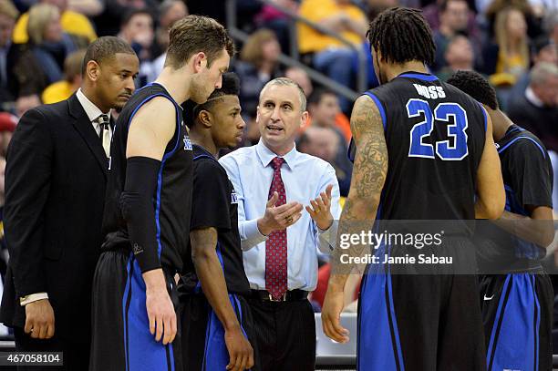 Head coach Bobby Hurley of the Buffalo Bulls speaks to his players in the second half against the West Virginia Mountaineers during the second round...