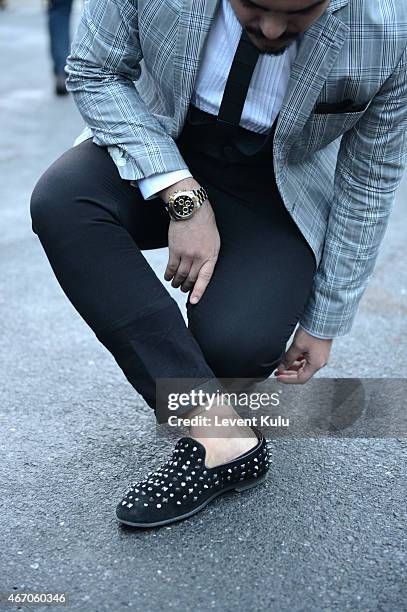 Koray Serkan Guzel poses wearing suit by Damat Tween, tie by Hextie, shoes by Christian Louboutin, watch by Rolex during Mercedes Benz Fashion Week...