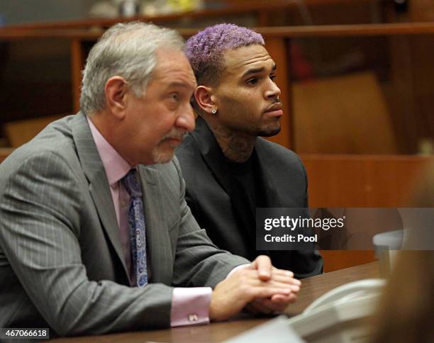 Singer Chris Brown and his lawyer Mark Geragos attend a progress hearing at Los Angeles Superior Court on MARCH 20, 2015 in Los Angeles, California....