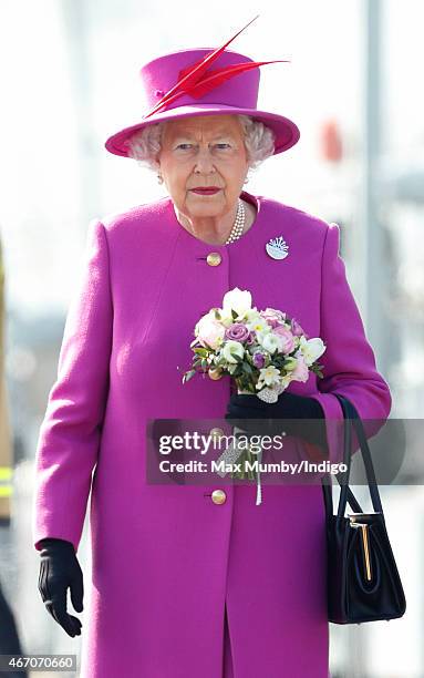 Queen Elizabeth II stands on the flight deck of HMS Ocean before departing by helicopter, following a visit to the ship at HM Naval Base Devonport on...