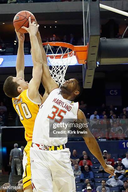 Damonte Dodd of the Maryland Terrapins jumps to block a shot by David Skara of the Valparaiso Crusaders during the second round of the Men's NCAA...