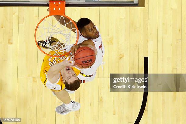 Jared Nickens of the Maryland Terrapins jumps to block a shot by David Skara of the Valparaiso Crusaders during the second round of the Men's NCAA...