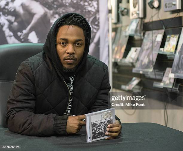 Hip-hop artist Kendrick Lamar signs copies of his new album "To Pimp A Butterfly" at Rough Trade NYC record store on March 20, 2015 in New York City.