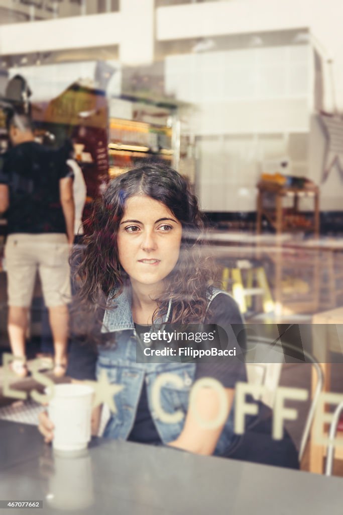Pensive Beautiful Young Woman Drinking Coffee
