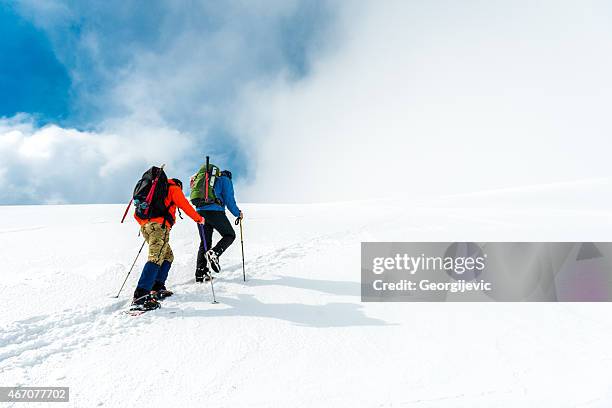 mountaineering - team climbing up to mountain top stock pictures, royalty-free photos & images