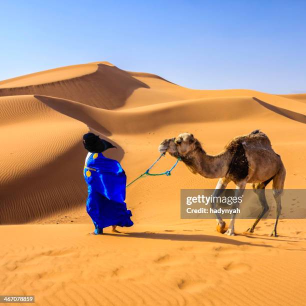 young tuareg with camel on western sahara desert in africa - zagora stock pictures, royalty-free photos & images