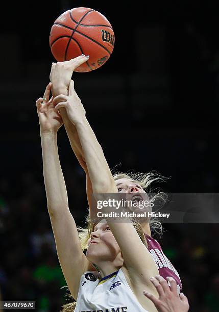 Madison Cable of the Notre Dame Fighting Irish and Maggie Rickman of the Montana Lady Grizzlies battle for a rebound during the first round of the...