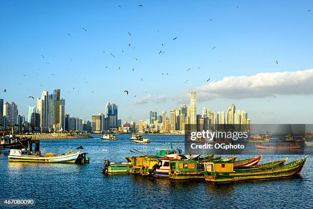 xxxl: fishing boats with panama city skyline - panama city stock pictures, royalty-free photos & images